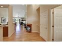 Hardwood floor hallway with view into living room and access to other rooms at 6678 S Shawnee Ct, Aurora, CO 80016