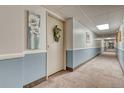 Clean condo hallway with light walls and carpeting at 13609 E Cornell Ave # 107, Aurora, CO 80014