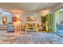 Spacious living area with a large window and wood-look floors at 13609 E Cornell Ave # 107, Aurora, CO 80014