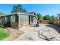 Green house with stone accents and a spacious driveway at 624 Stuart St, Denver, CO 80204