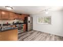 Cozy kitchen with stainless steel appliances and wood cabinets at 420 Willow Dr, Lochbuie, CO 80603