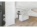 Modern kitchen island, stainless steel appliances, and light-colored cabinets at 8827 Snake River St, Littleton, CO 80125