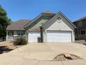 Two-story house with a two-car garage and landscaped front yard at 1266 S Ammons St, Lakewood, CO 80232
