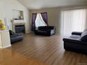 Spacious living room with hardwood floors and a fireplace at 1266 S Ammons St, Lakewood, CO 80232