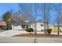 Ranch style home with a freshly painted exterior and mature trees at 3661 Miller St, Wheat Ridge, CO 80033