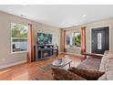 Bright living room with hardwood floors, fireplace, and comfortable seating at 5555 Perth Ct, Denver, CO 80249