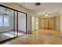 Living room with hardwood floors, sliding glass doors, and ceiling fans at 3333 Colorado Blvd, Denver, CO 80205