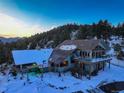 Two-story home with a large deck and mountain views at 5237 Bear Mountain Dr, Evergreen, CO 80439