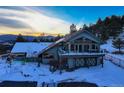 Two-story home with a large deck and mountain views at 5237 Bear Mountain Dr, Evergreen, CO 80439
