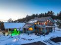 Two-story home with a large deck and mountain views at 5237 Bear Mountain Dr, Evergreen, CO 80439