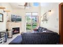 Living room with sectional sofa and fireplace, access to backyard at 34 Highfield Trail # 100, Breckenridge, CO 80424