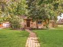 Charming ranch home with well-manicured lawn and walkway at 2680 S Garfield Cir, Denver, CO 80210