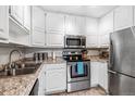 Bright kitchen featuring stainless steel appliances and white cabinetry at 350 S Clinton St # 4A, Denver, CO 80247