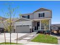 Two-story house with gray siding, stone accents, and a two-car garage at 3453 N Irvington St, Aurora, CO 80019