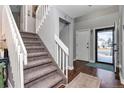 Inviting entryway with staircase, hardwood floors, and a view to the backyard at 11507 Depew Ct, Broomfield, CO 80020