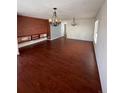 Dining room with hardwood floors, brick accent wall, and chandelier at 21476 E 53Rd Pl, Denver, CO 80249