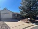 Front view of a ranch home with a two car garage at 15038 E Greenwood Pl, Aurora, CO 80014