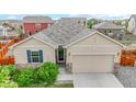 Aerial view of a tan one-story house with a two-car garage at 1824 Ruby Ct, Brighton, CO 80603