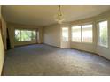 Bright living room featuring ample natural light from multiple windows and a chandelier at 20420 Kelly Pl, Denver, CO 80249