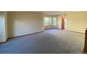 Spacious living room with large windows, hardwood floors, and a chandelier at 20420 Kelly Pl, Denver, CO 80249