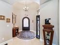 Elegant entryway with arched doorway and tiled flooring at 1399 Gore Cir, Larkspur, CO 80118