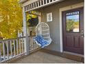 Relaxing porch with a hanging chair and inviting entryway at 2135 Spruce St # 4, Boulder, CO 80302