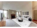 Living room with fireplace, vaulted ceiling and large windows at 8731 Dawson St # 303, Denver, CO 80229