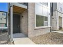 Modern front entrance with a dark door and stone accents at 461 Interlocken Blvd # 105, Broomfield, CO 80021