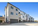 Row of contemporary townhouses with attached garages at 461 Interlocken Blvd # 105, Broomfield, CO 80021