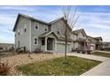 Two-story house with gray siding, two-car garage, and a view of the neighborhood at 4606 N Bend Way, Firestone, CO 80504