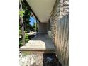Stone front porch with a concrete landing and wooden fence at 14190 E Gunnison Pl, Aurora, CO 80012