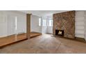 Living room with a stone fireplace and hardwood floors at 13657 E Yale Ave # A, Aurora, CO 80014