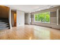 Spacious living room featuring hardwood floors and a view to the outdoors at 9079 E Nassau Ave, Denver, CO 80237