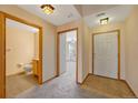 Bright entryway with tile flooring, powder room, and access to living room at 8201 S Winnipeg Ct, Aurora, CO 80016