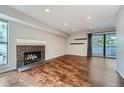 Living room with hardwood floors, fireplace and balcony access at 6420 S Dayton St # J06, Englewood, CO 80111