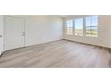 Bright living room with grey tile flooring and large windows at 9152 Gladiola Way # F, Arvada, CO 80005