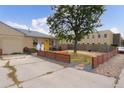 Ranch home with a small front yard, wooden fence, and landscaping at 262 S Bryant St, Denver, CO 80219