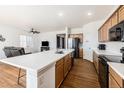 Open concept kitchen with island and living area at 27840 E 7Th Pl, Aurora, CO 80018