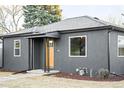 Gray craftsman home with wood front door and updated landscaping at 1698 S Garfield St, Denver, CO 80210