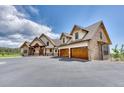 Stunning two-story home with stone accents and a three-car garage at 5236 Bear Mountain Dr, Evergreen, CO 80439