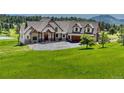 Luxury home with a large yard and mountain views at 5236 Bear Mountain Dr, Evergreen, CO 80439