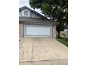 Attached garage with a gray and white striped door at 2213 S Kingston Ct, Aurora, CO 80014