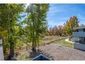 Partial view of backyard with trees and a gravel patio at 1111 Elysian Field Dr # D, Lafayette, CO 80026