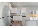 Modern kitchen with stainless steel appliances and granite countertops at 7208 Big Thompson Ct, Frederick, CO 80530