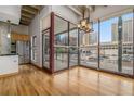 Bright dining area with hardwood floors and access to a balcony with city views at 1020 15Th St # 202, Denver, CO 80202