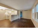 Open living room with kitchen and hardwood floors at 6705 S Field St # 803, Littleton, CO 80128