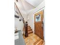 Elegant entryway with hardwood floors, stained glass door, and ornate staircase at 3753 Vallejo St, Denver, CO 80211