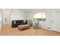 Living room featuring hardwood floors, ample natural light, and comfortable seating at 1575 S Clermont St, Denver, CO 80222