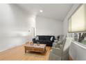Bright living room with hardwood floors, comfy seating, and large windows at 1575 S Clermont St, Denver, CO 80222