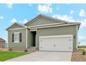 Green house exterior with 2-car garage at 2144 Alyssa St, Fort Lupton, CO 80621